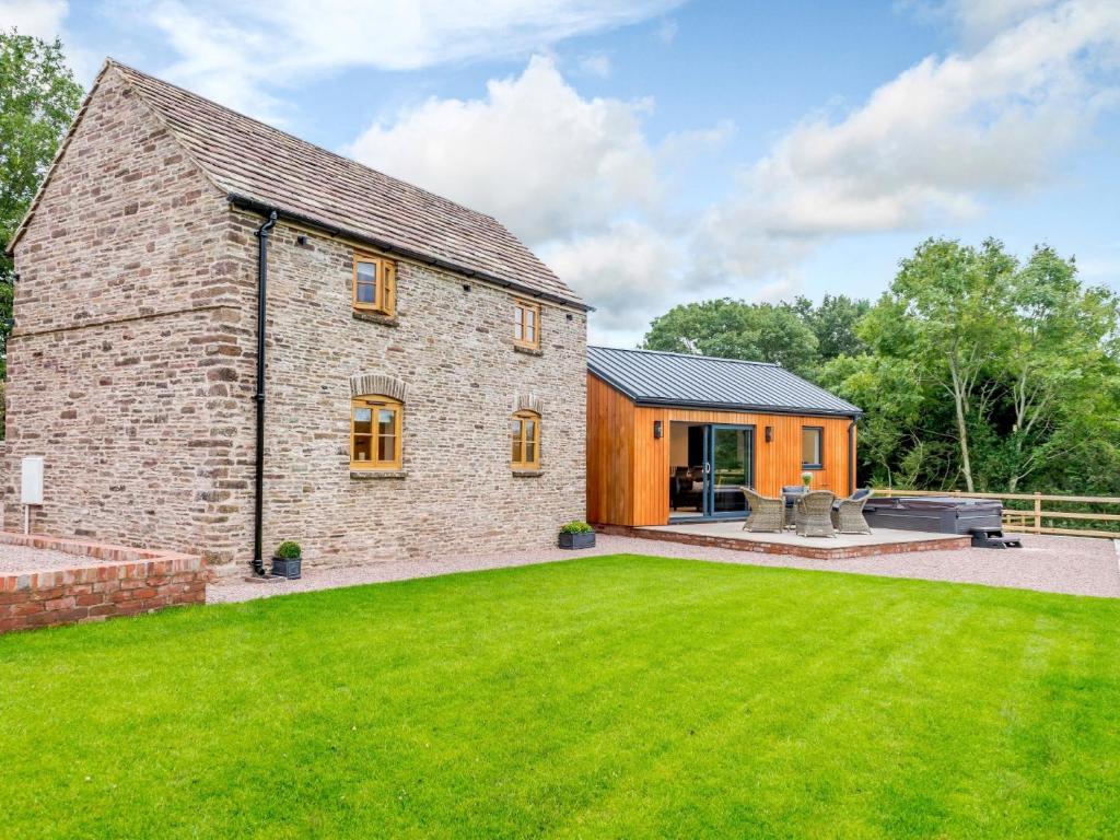 an old stone house with a green lawn at 2 Bed in Longtown 79176 