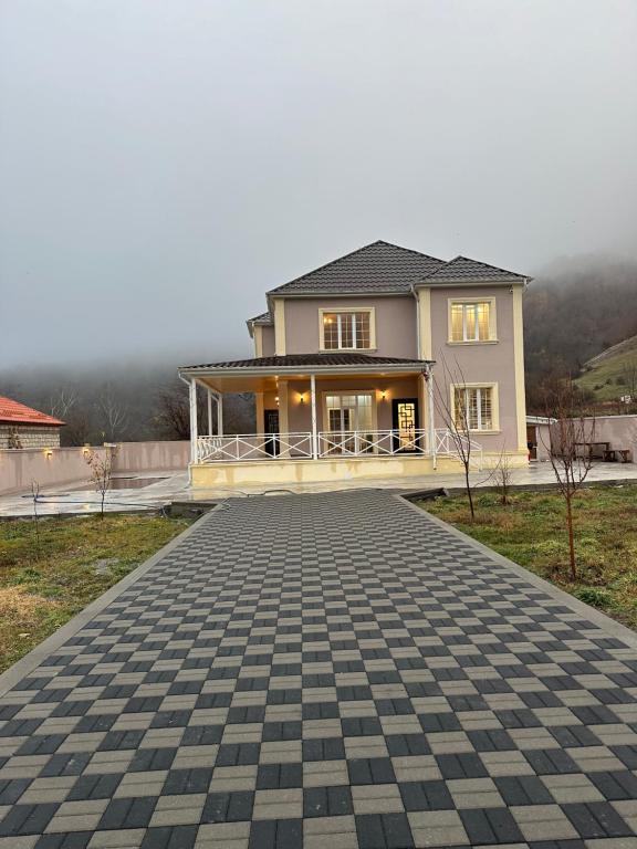 a house with a driveway in front of it at JLYN HOUSE in İsmayıllı
