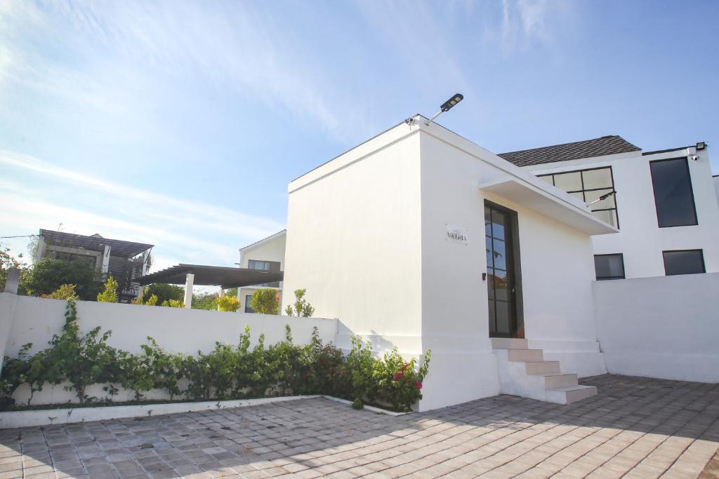 a white house with a white fence at Villa Valeria in Ungasan