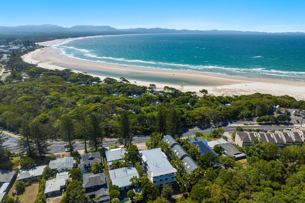 een luchtzicht op een strand met huizen en de oceaan bij Cape Apartments in Byron Bay