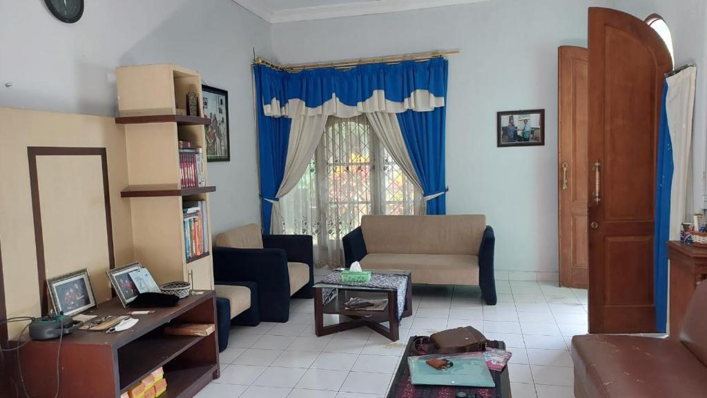 a living room with a couch and a table at Kluwih House in Godean