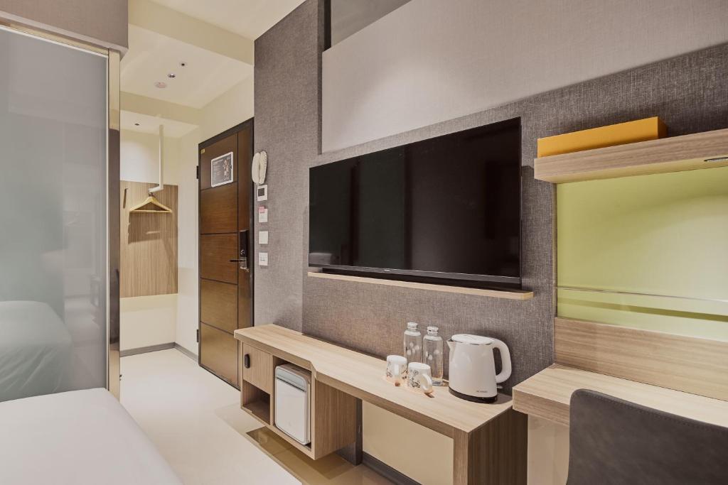 Postel nebo postele na pokoji v ubytování Orange Hotel -Hanzhong, Taipei