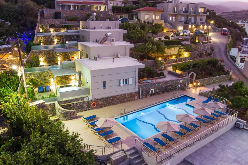 einen Luftblick auf eine Villa mit einem Pool in der Nacht in der Unterkunft Kavousanos Apartments in Istro