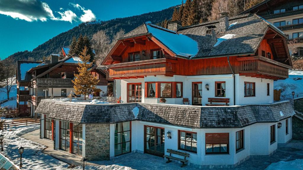 a home in the mountains with snow on the ground at Villa Bostele with Seven Bedrooms, Indoor Pool and Two Saunas in Bad Kleinkirchheim