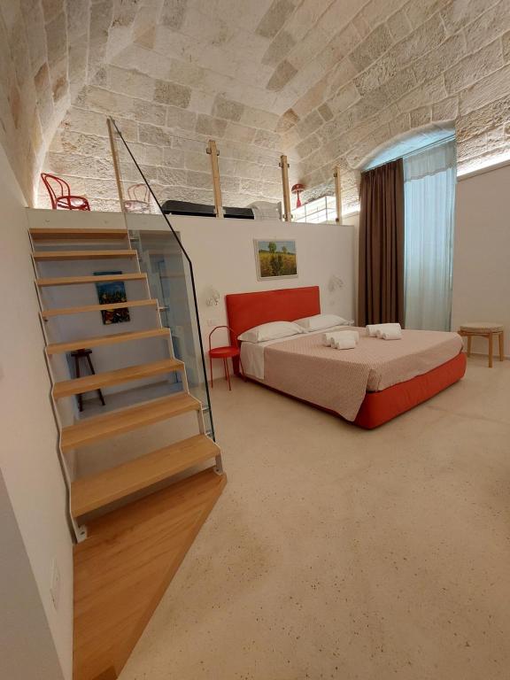 a bedroom with a bed and a staircase in a room at MandorleOlio in Polignano a Mare