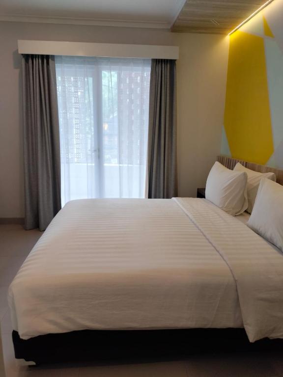 Postel nebo postele na pokoji v ubytování Key Inn Hotel Bogor