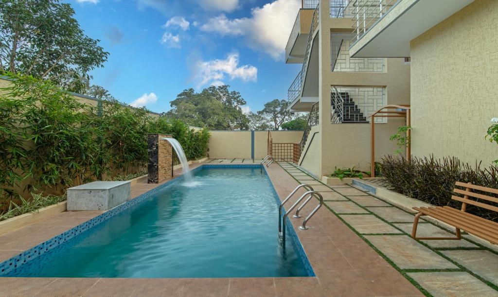 a swimming pool with a fountain in a house at Itsy Hotels Kurinji Stay Inn in Yelagiri