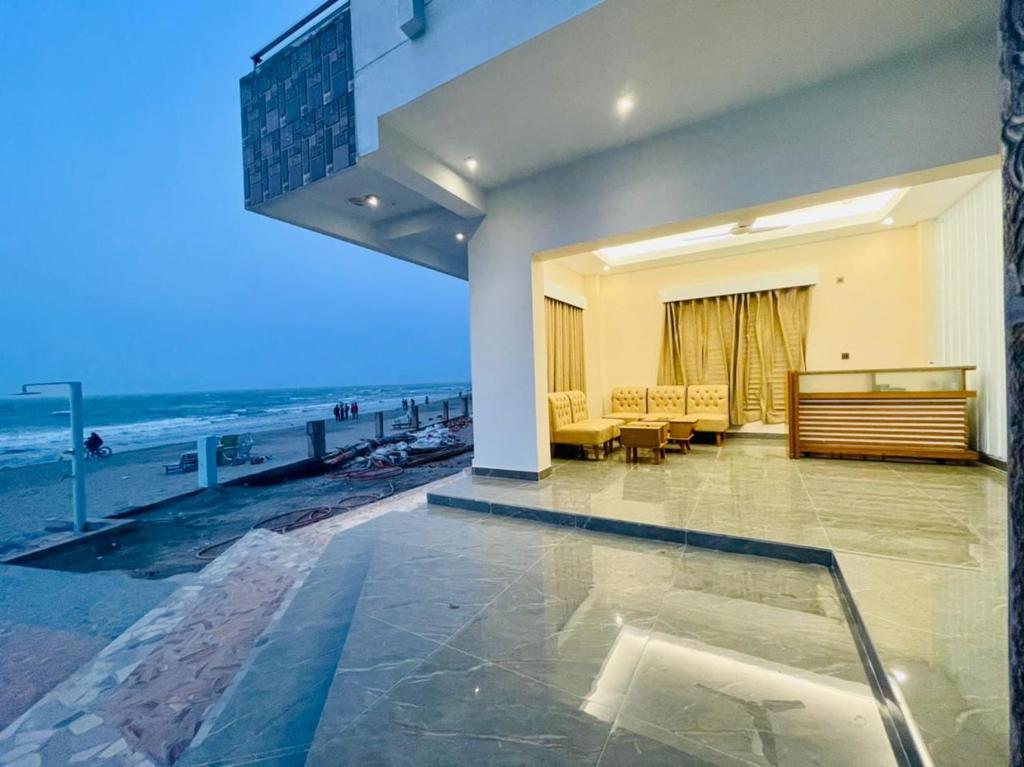 a living room with a view of the ocean at Dreamers Paradise in Jaliapāra