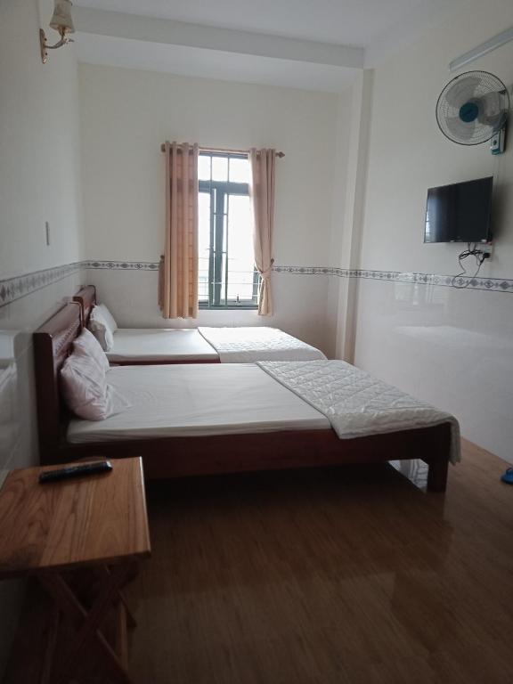 Postel nebo postele na pokoji v ubytování Tam Ky XO Hotel