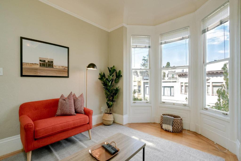 a living room with a red chair and a table at Missions Dolores 1br nr dining cafes shops SFO-1621 in San Francisco