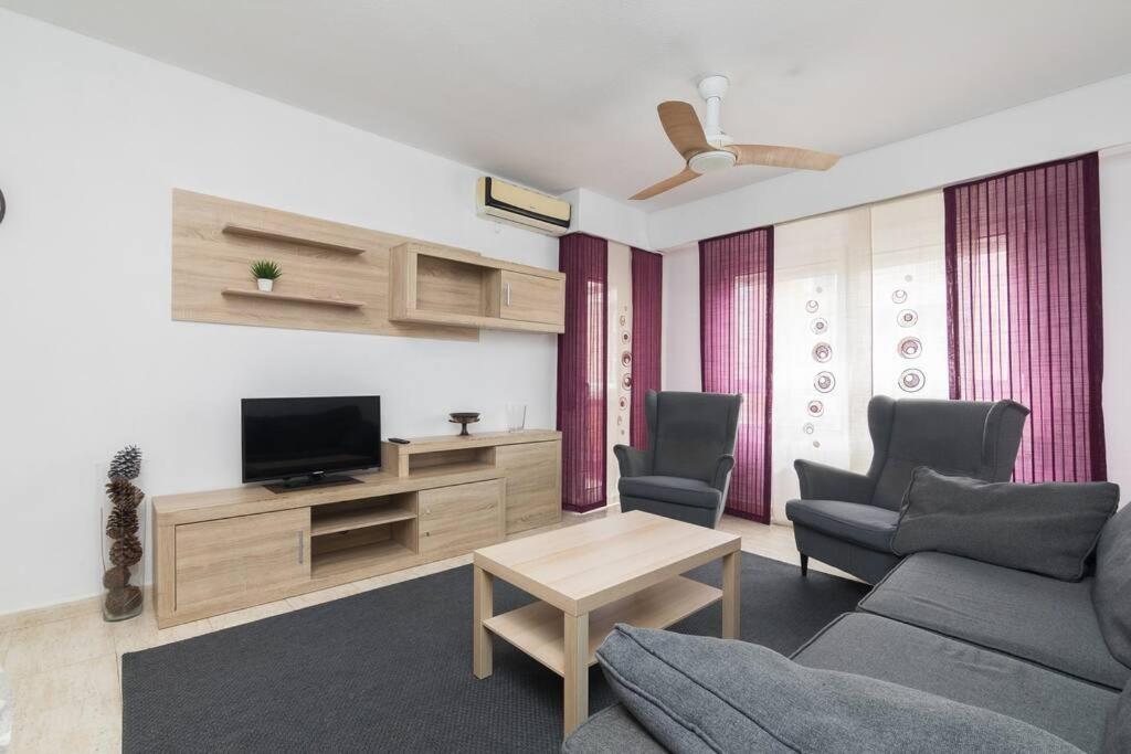 a living room with a couch and a tv at Marina - Delicia al sur in El Altet