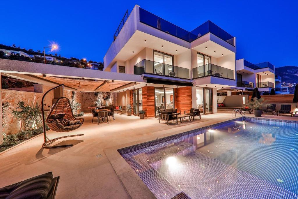 a house with a swimming pool in front of it at Villa Eos - Kalkan Villa in Kaş