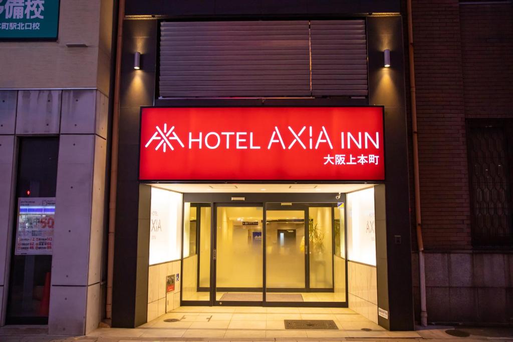 a hotel akoya inn sign on the side of a building at Hotel Axiainn Osaka-Uehonmachi in Osaka