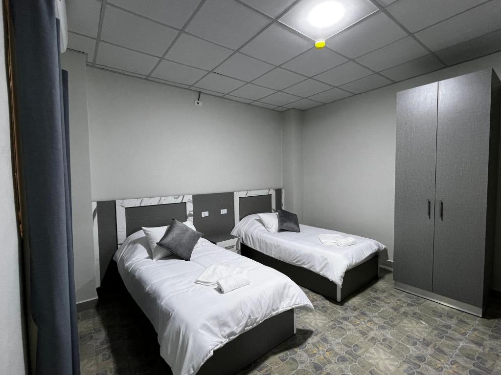 Postel nebo postele na pokoji v ubytování Downtown Inn Madaba