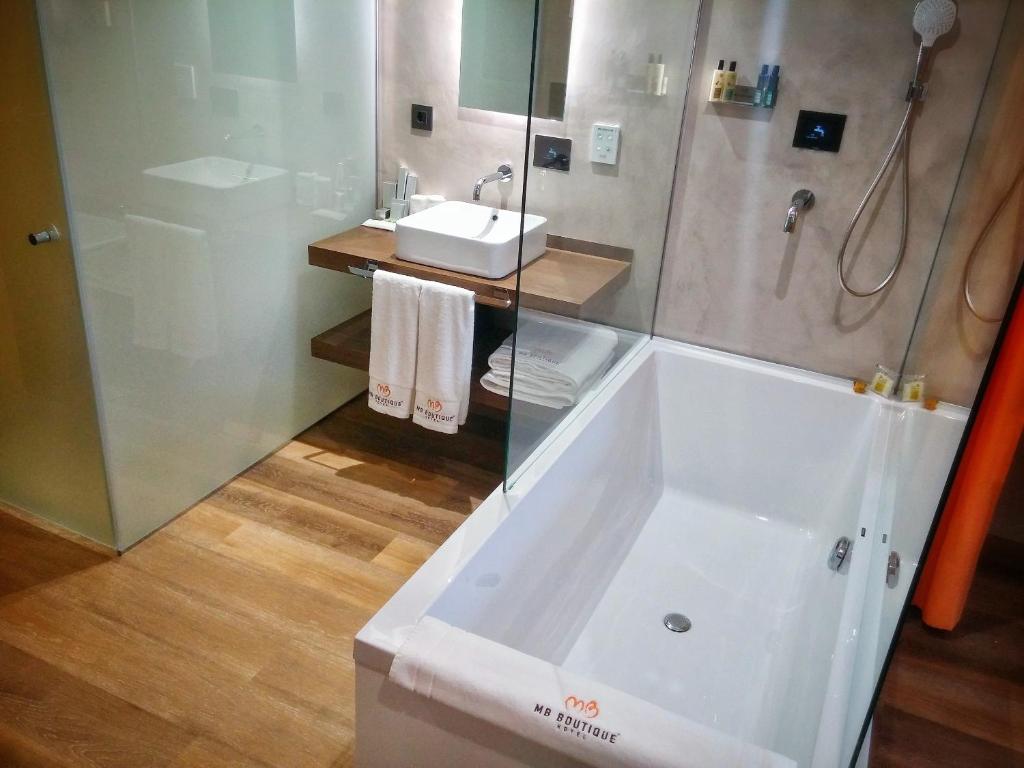 a bathroom with a tub and a sink and a shower at MB Boutique Hotel - Adults Recommended in Nerja