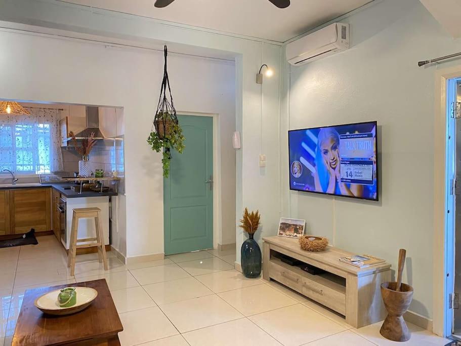 a living room with a flat screen tv on a wall at La belle rencontre in Mamoudzou
