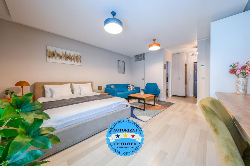 a bedroom with a bed and a blue chair at My Place Dorobantilor in Cluj-Napoca