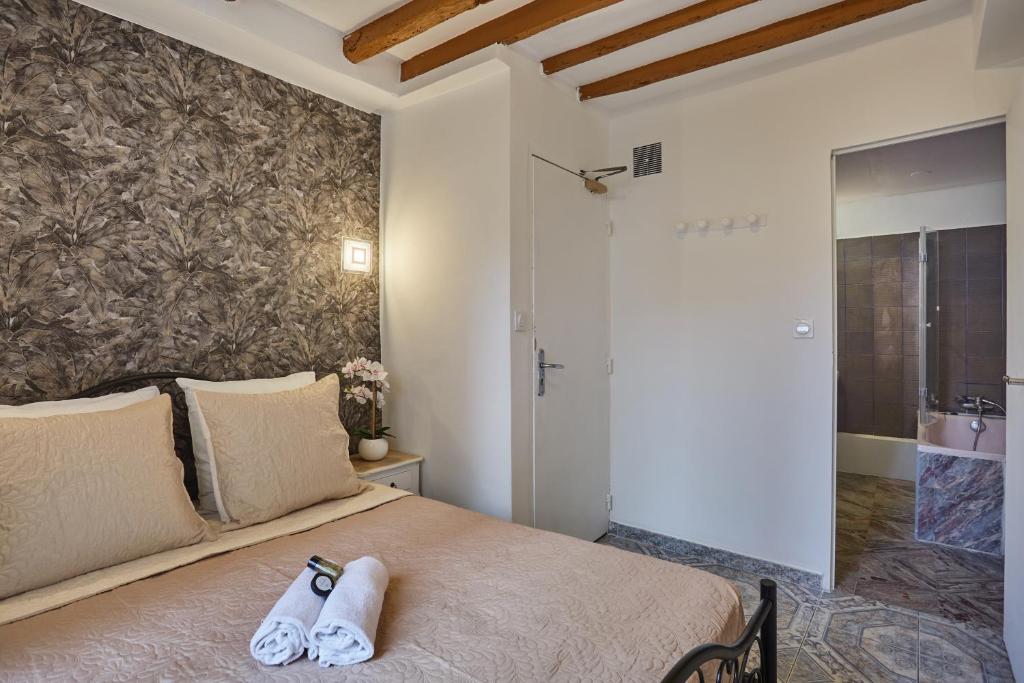 a bedroom with a bed with two towels on it at Hotel Petit Vix in Paris