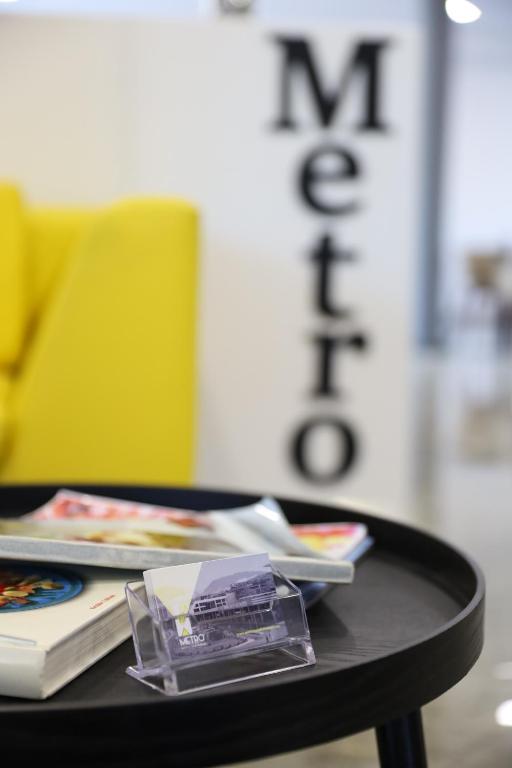 a table with books and magazines on top of it at Metro Hotel Terminal in Tirana