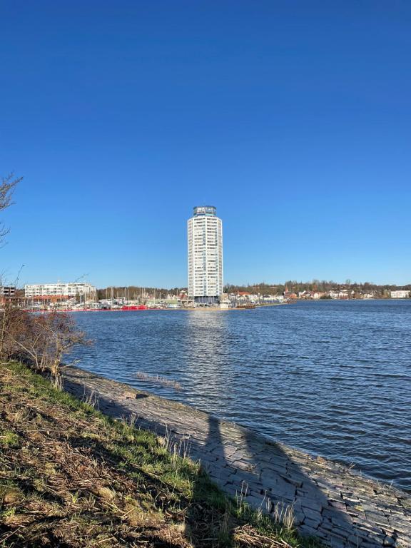 a tall building sitting on the side of a river at Schleibude in Schleswig