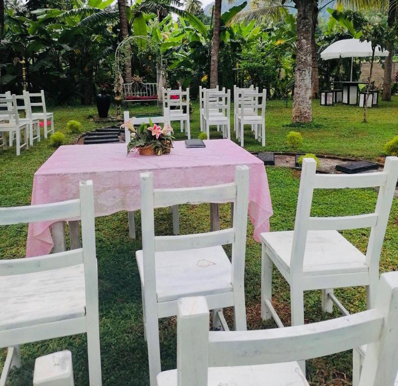 a table with white chairs and a pink table cloth at Miracle Sand Country Resort in Mawatagama