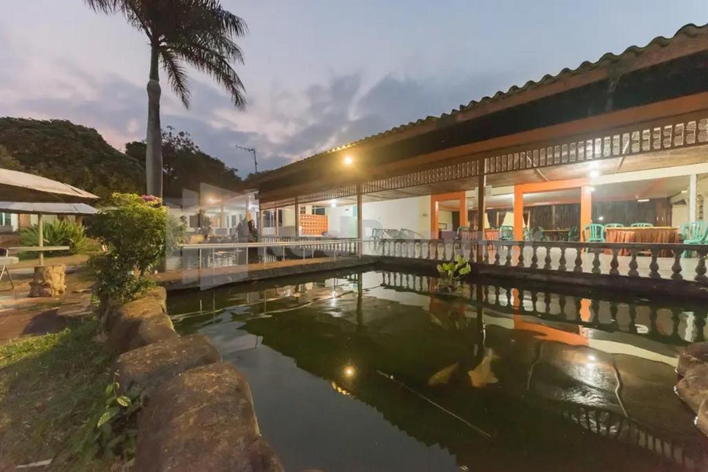 een hotel met een zwembad voor een gebouw bij Hotel Linggarjati near Natural Park TWA Linggarjati in Bojong