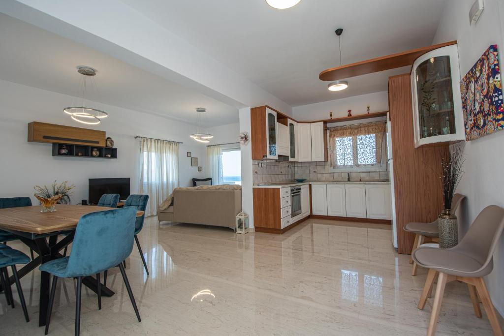 a kitchen and living room with a table and chairs at Istron MiraBella Villas in Istron