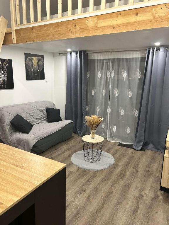 un salon avec un canapé et une table dans l'établissement Beau petit studio avec terrasse et 2 couchages, à Fos-sur-Mer