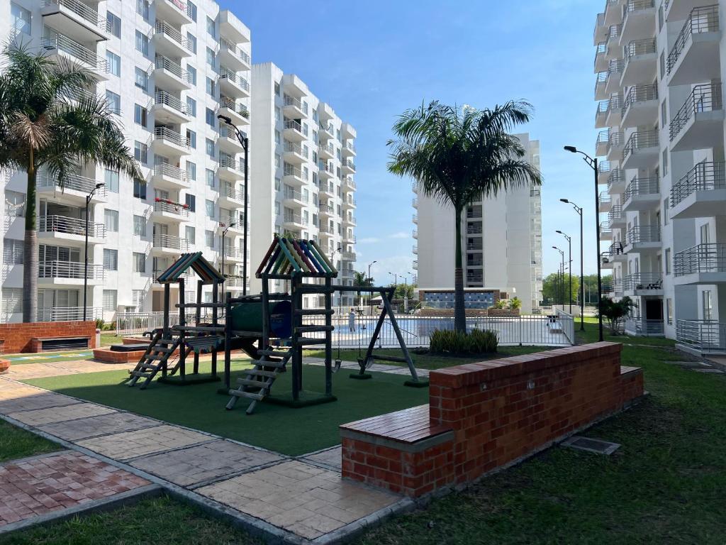 a playground with a swing set in a park at Hermoso apartamento para descansar en familia in Girardot