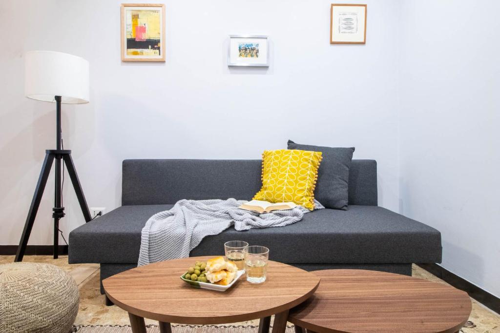 a living room with a couch and a table at AZURE RETREAT Apartment in Camogli