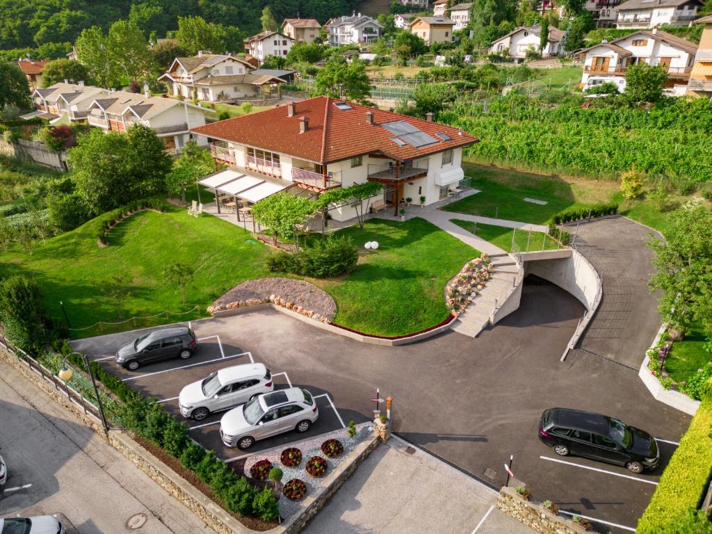 an aerial view of a house with cars parked in a parking lot at Garnì Tuttotondo in Levico Terme