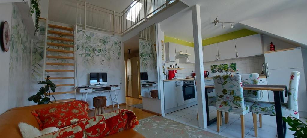 a living room with a couch and a kitchen at Ruhiges & zentrales Loft in Lörrach in Lörrach