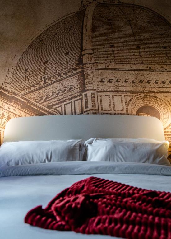 A bed or beds in a room at Acacia Firenze - Girasole