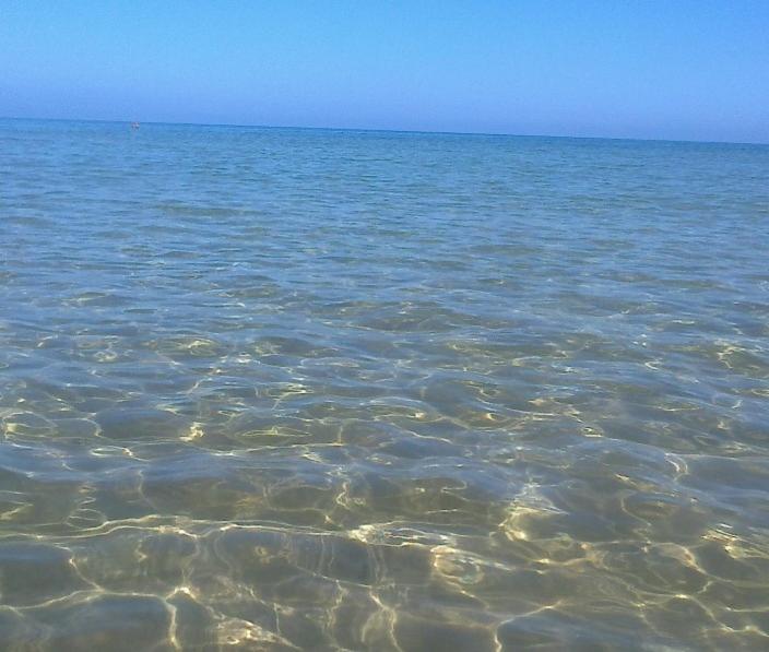 a large body of water with rocks in it at Apartment Calatubo in Alcamo Marina