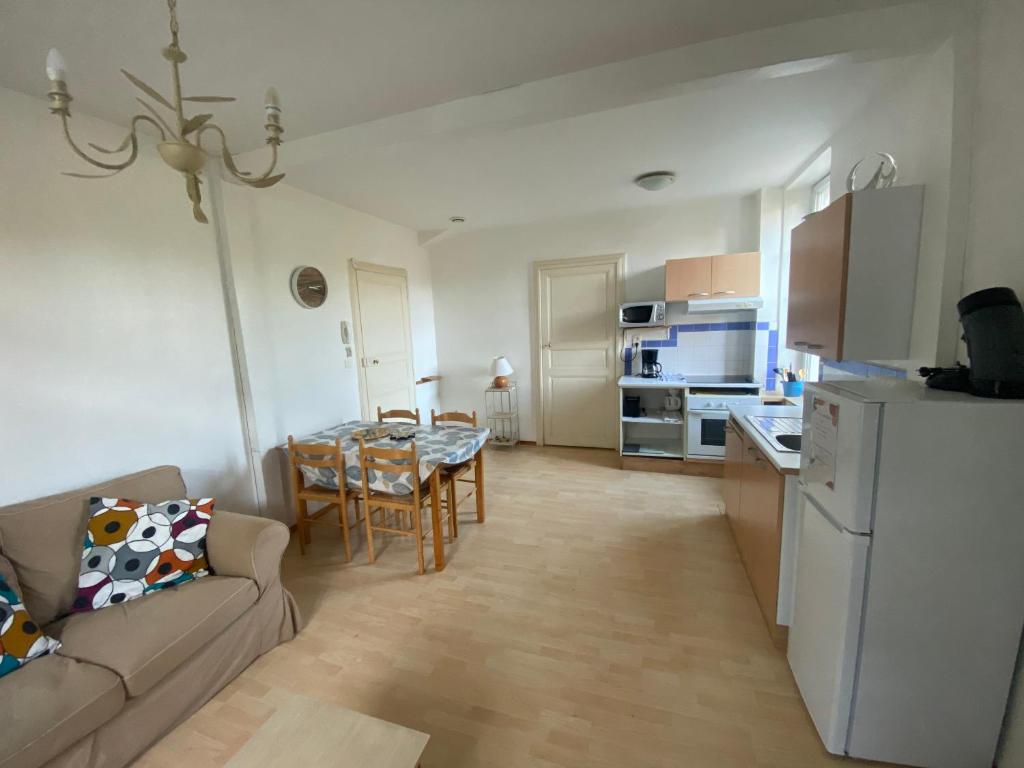 a living room with a couch and a table at Les Platanes - Gaugain in Lamalou-les-Bains