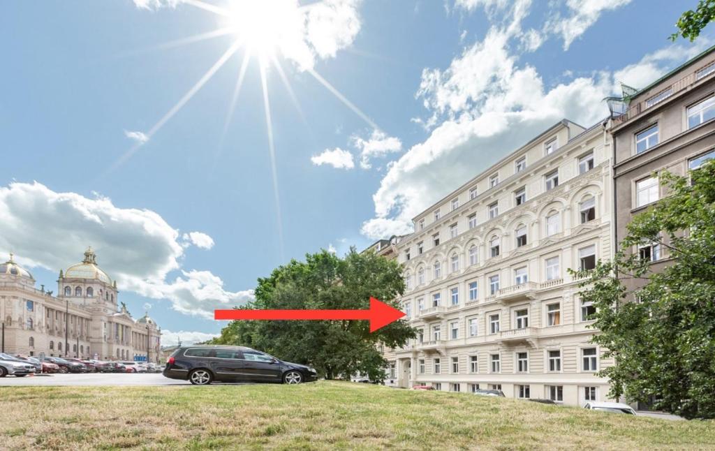 a car parked in front of a building with a red arrow at Helen Homestay 50m from Wenceslas Square in Prague