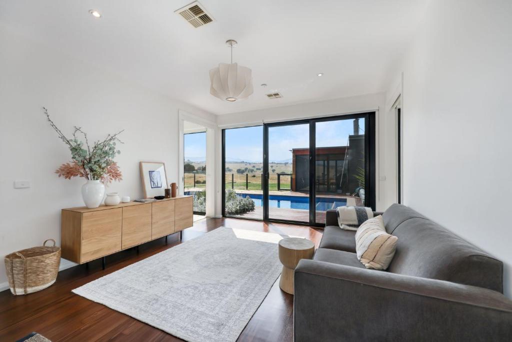 ein Wohnzimmer mit Sofa und Tisch in der Unterkunft Merrivale Hill, Merrijig - Sleeps 10 in Merrijig