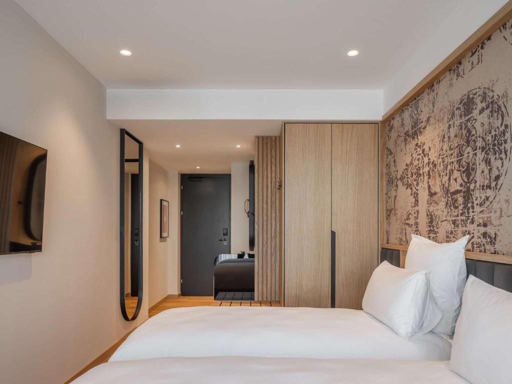 Postel nebo postele na pokoji v ubytování Mercure Prishtina City