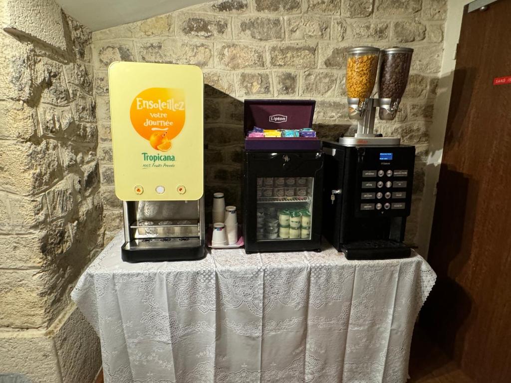a table with a coffee maker on it with a coffee maker at 121 Paris Hotel in Paris