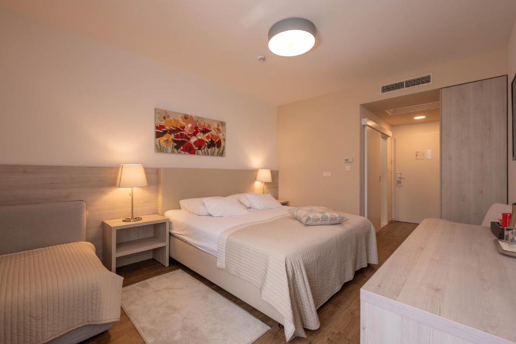 Postel nebo postele na pokoji v ubytování Hotel Magdalena