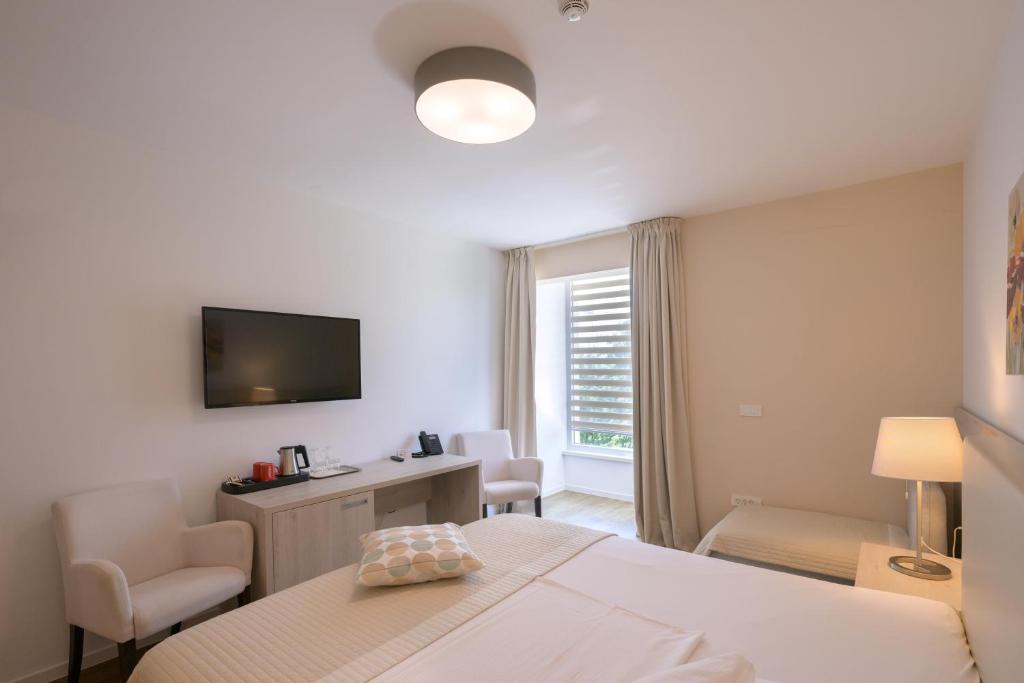Postel nebo postele na pokoji v ubytování Hotel Magdalena