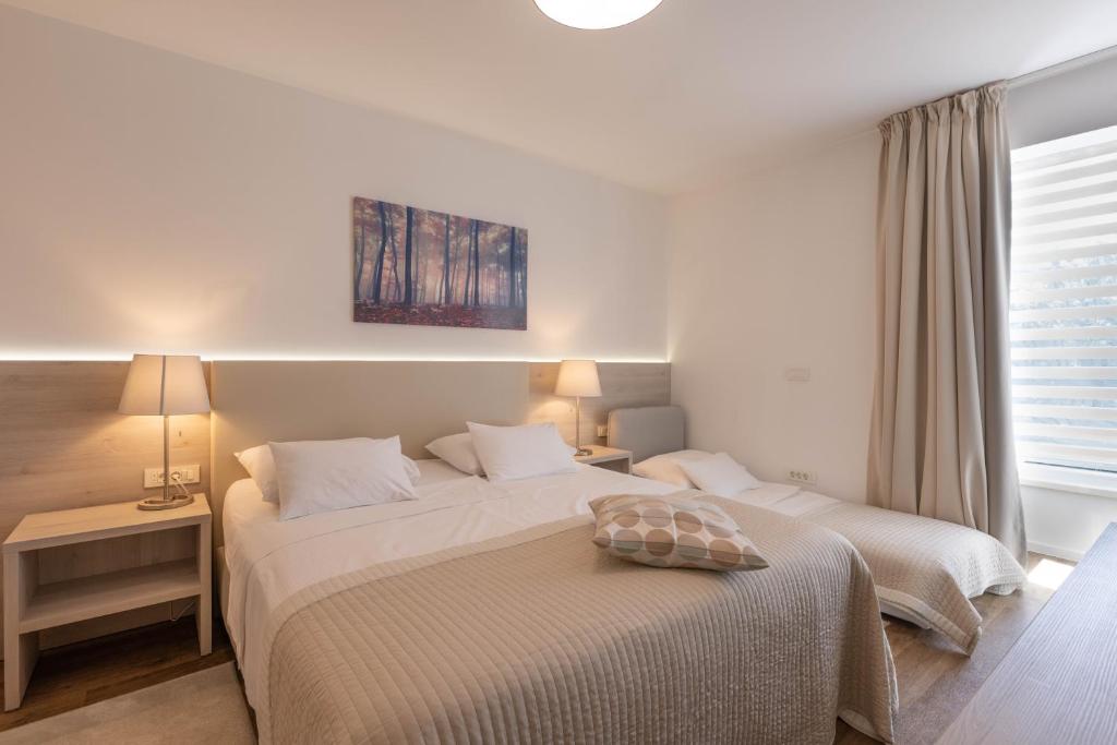 Postel nebo postele na pokoji v ubytování Hotel Magdalena