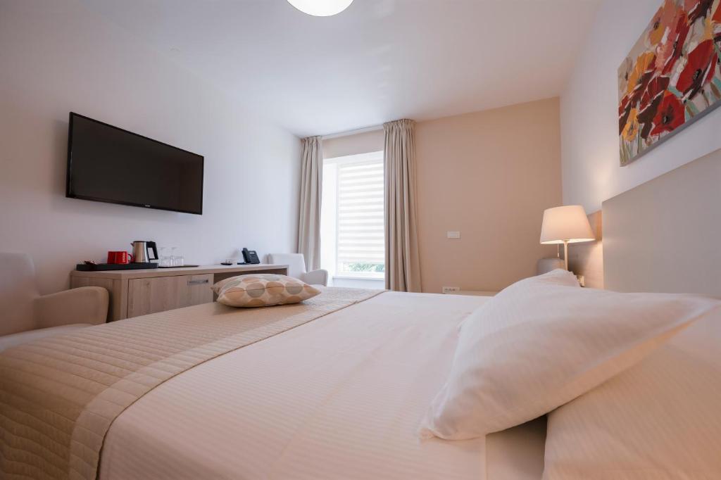 Postel nebo postele na pokoji v ubytování Hotel Magdalena