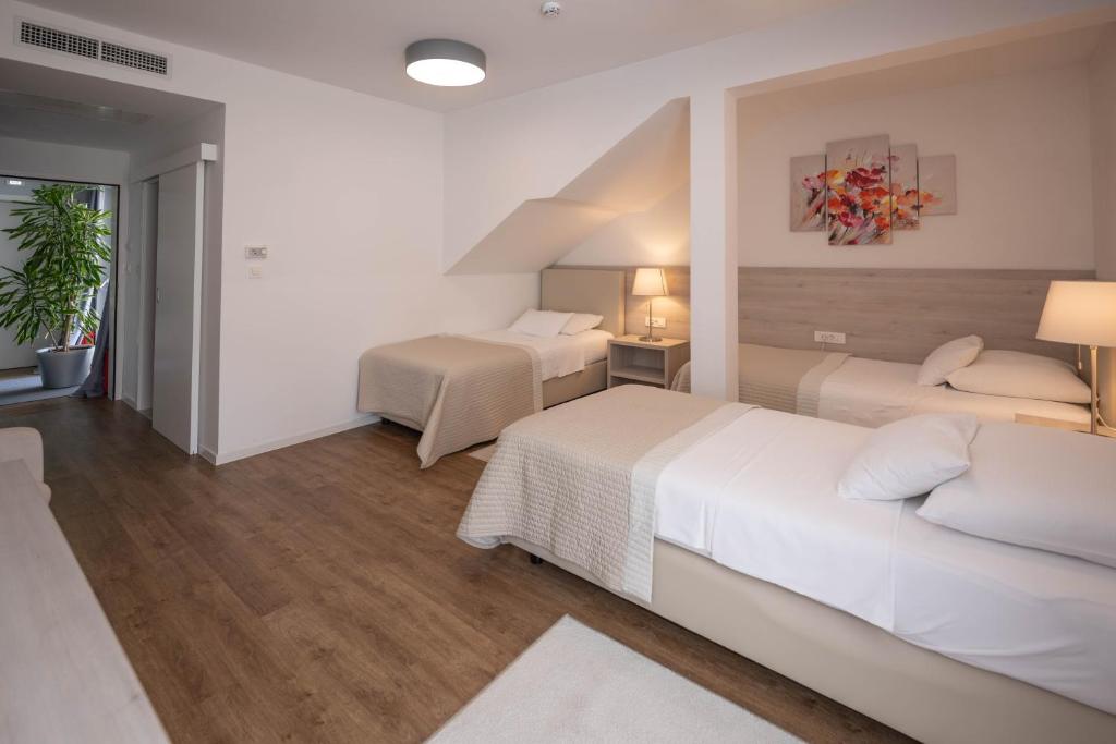 Postel nebo postele na pokoji v ubytování Hotel Magdalena