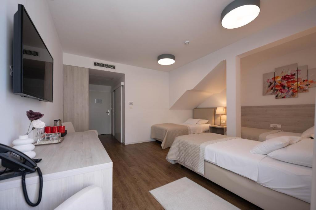 Postel nebo postele na pokoji v ubytování Hotel Magdalena