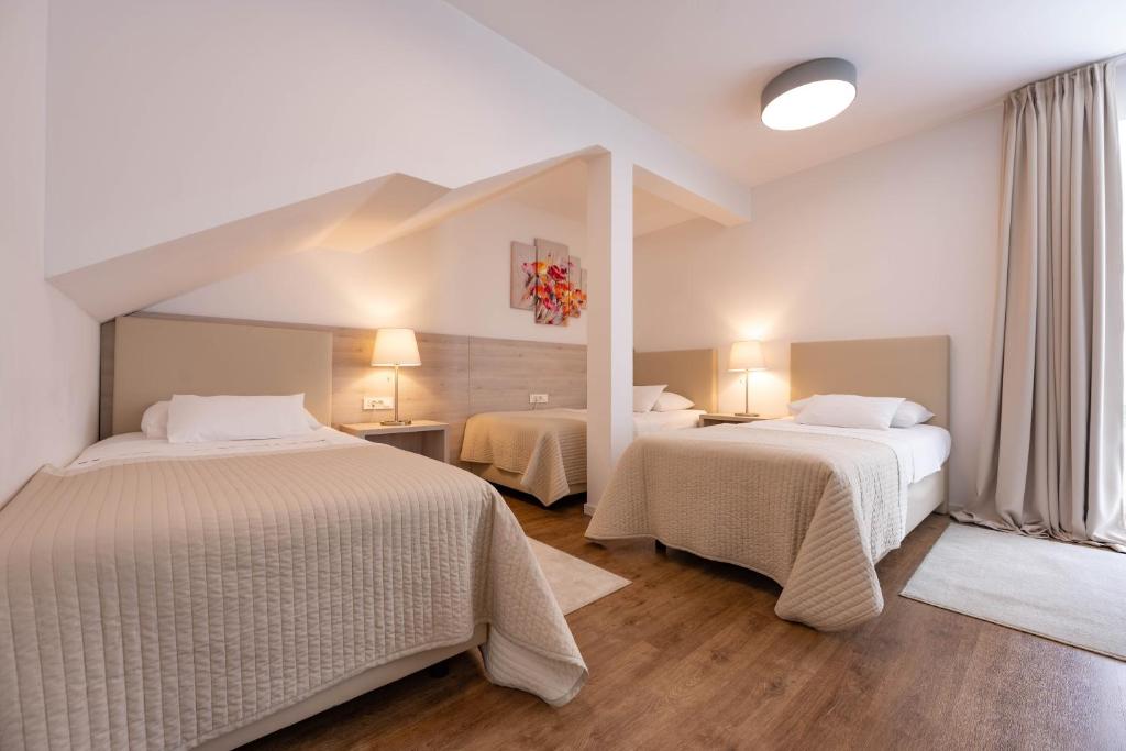 Postel nebo postele na pokoji v ubytování Hotel Magdalena