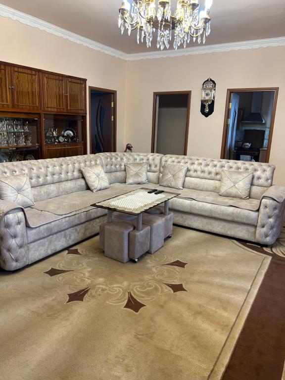 a living room with a couch and a table at Apartment in Tsaghkadzor