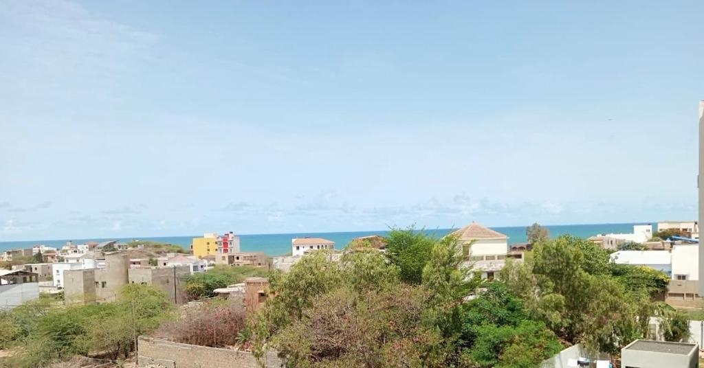 a city with buildings and the ocean in the background at La Villa Maria in Dakar