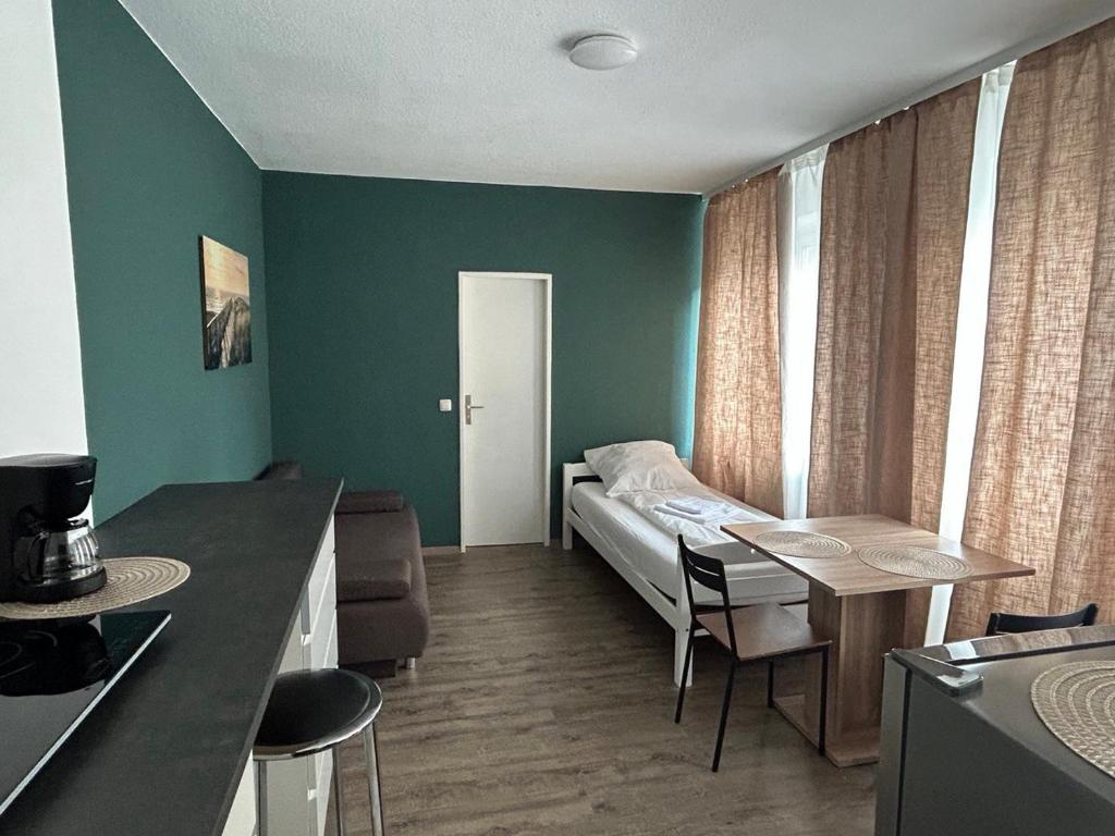 a small room with a bed and a table in it at SkyApartment#101 in Frankfurt/Main
