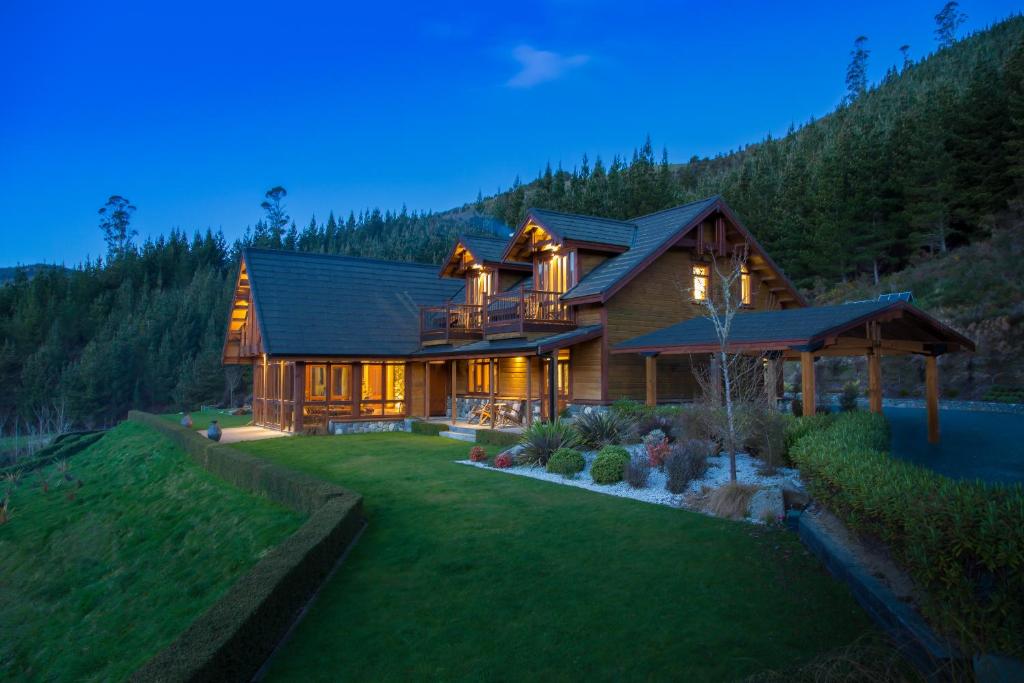 a large wooden house with a landscaping at Stonefly Lodge in Stanley Brook